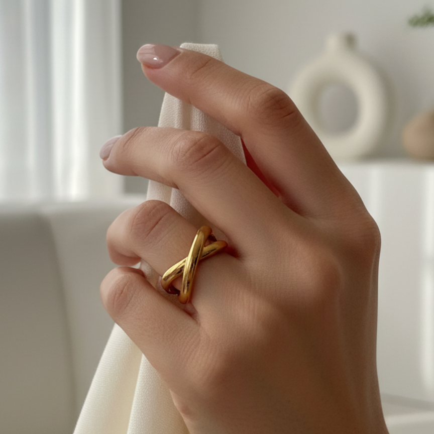hand wearing the ring beige background